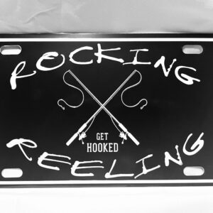 A black license plate frame with white text saying 'Rocking & Reeling' and 'Get Hooked'.